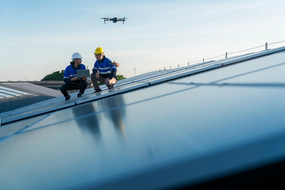 Professional installers use a drone to perform a solar site survey.