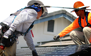 solar installer inspecting panels