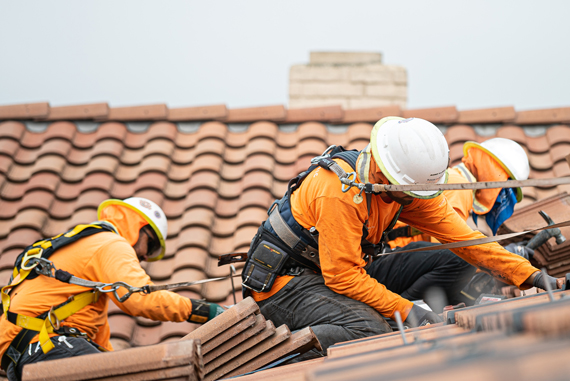 workers relacing roof