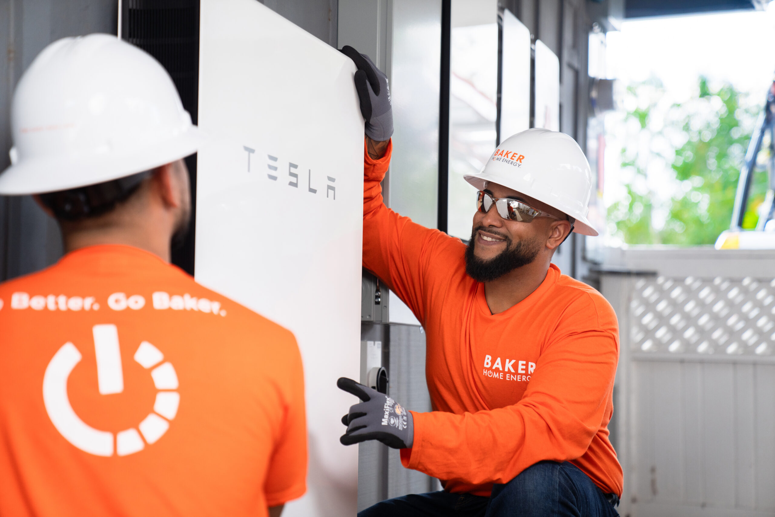 Baker Employees Installing a Tesla Battery