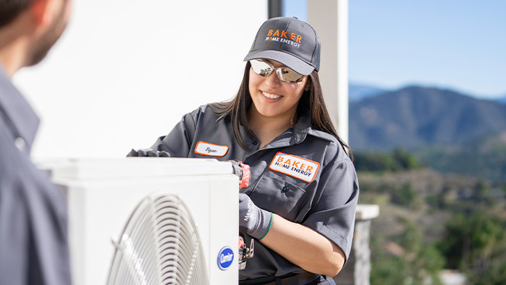 Baker HVAC Technician maintaining a Carrier AC Condenser