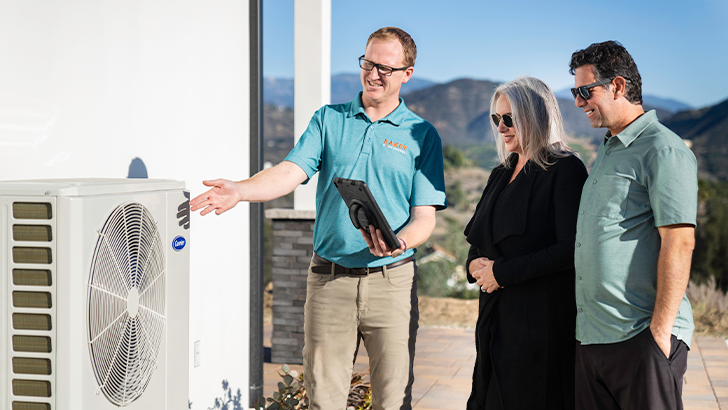 Baker HVAC Comfort Advisor advising a couple about an AC Condenser